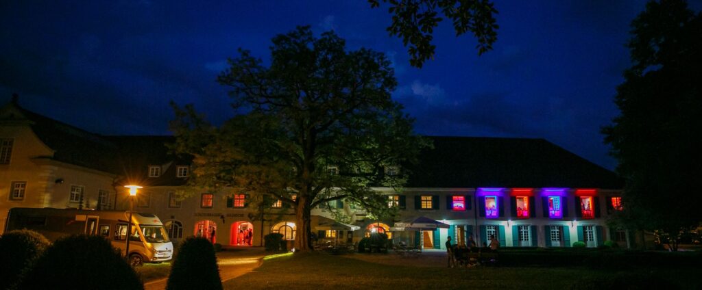 Die Schlossbrauerei Aulendorf in der Dunkelheit, stimmungsvoll beleuchtet.